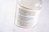 Rückseite der Salcombe Spiced White Rum Flasche mit einer Beschreibung der historischen Handelsrouten und der Rumherstellung.
